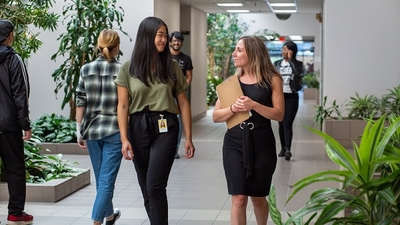 Matrox employees smiling and walking through hallway
